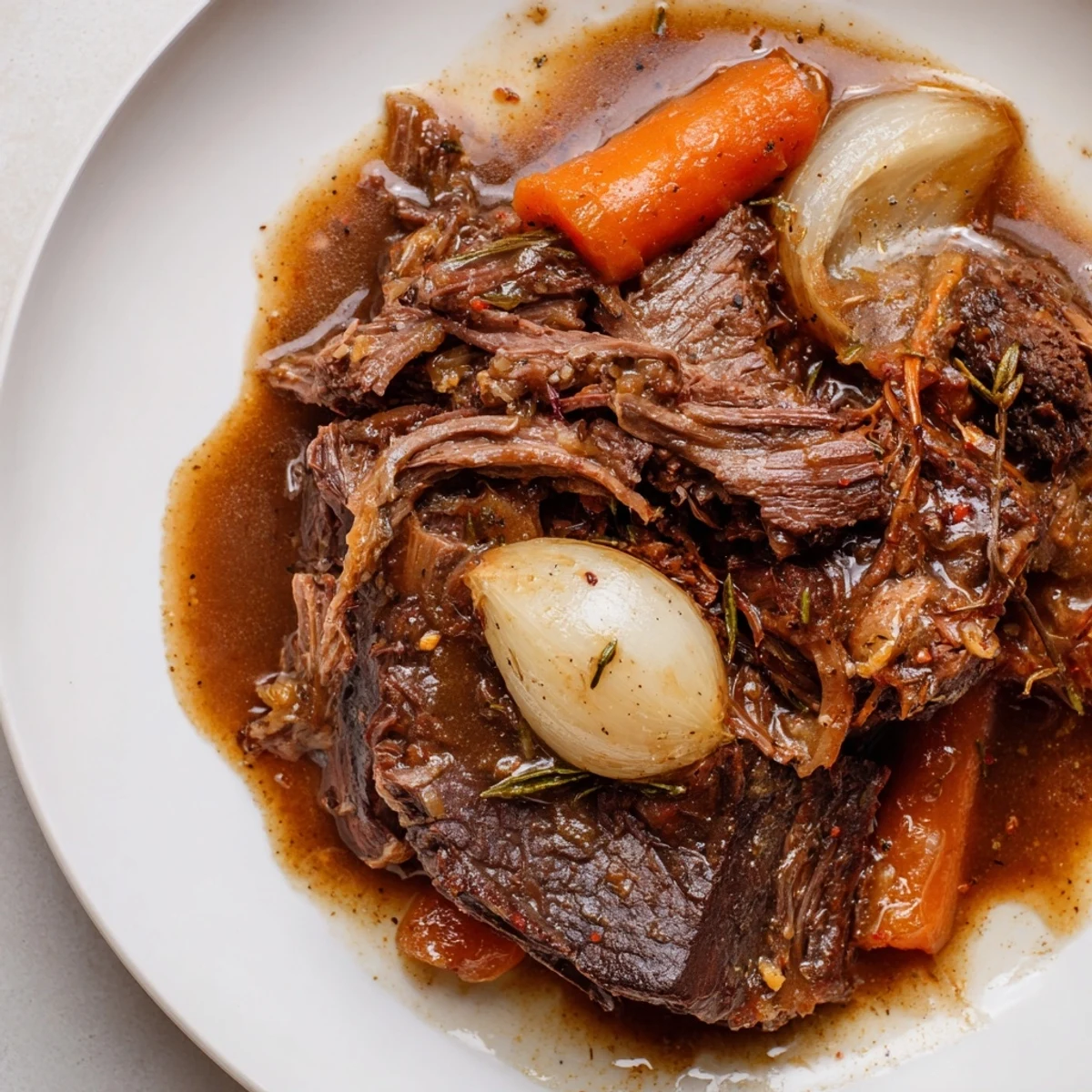A rustic slow cooker serving of Slow Cooker Roast Beef with Gravy beside steamed green beans and a side of creamy mashed potatoes.