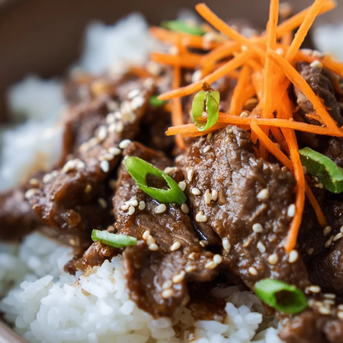 Hot Beef Bowl with Steamed Rice, topped with sliced green onions and sesame seeds, served in a ceramic bowl.