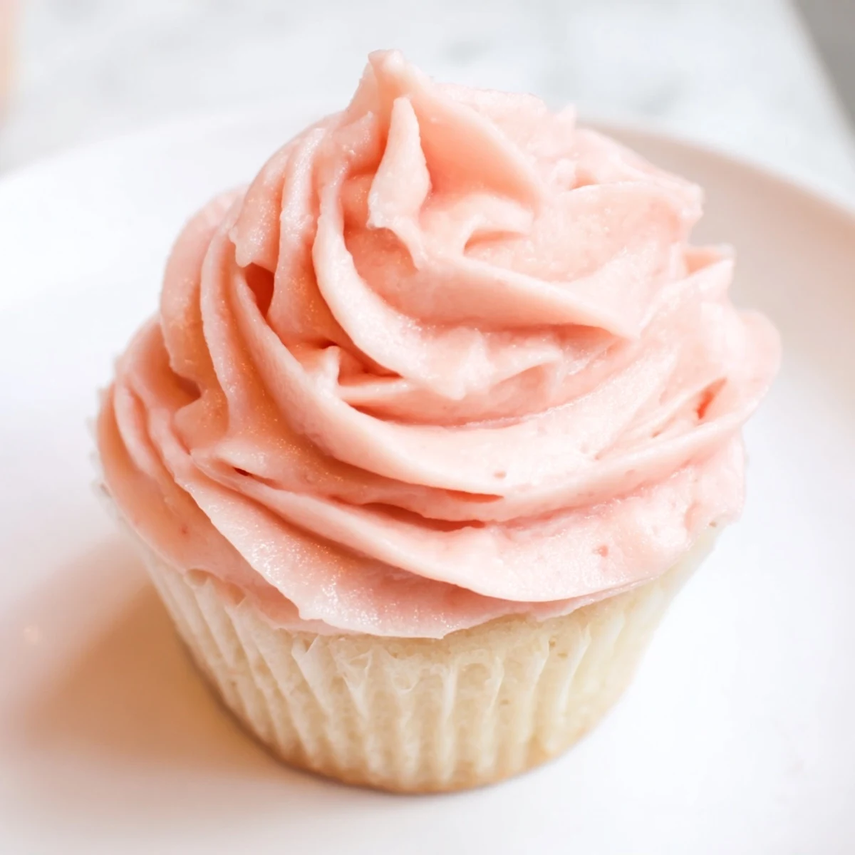 Freshly baked Valentine Pink Champagne cupcakes with pink buttercream frosting and edible glitter for a festive Valentine's Day dessert.