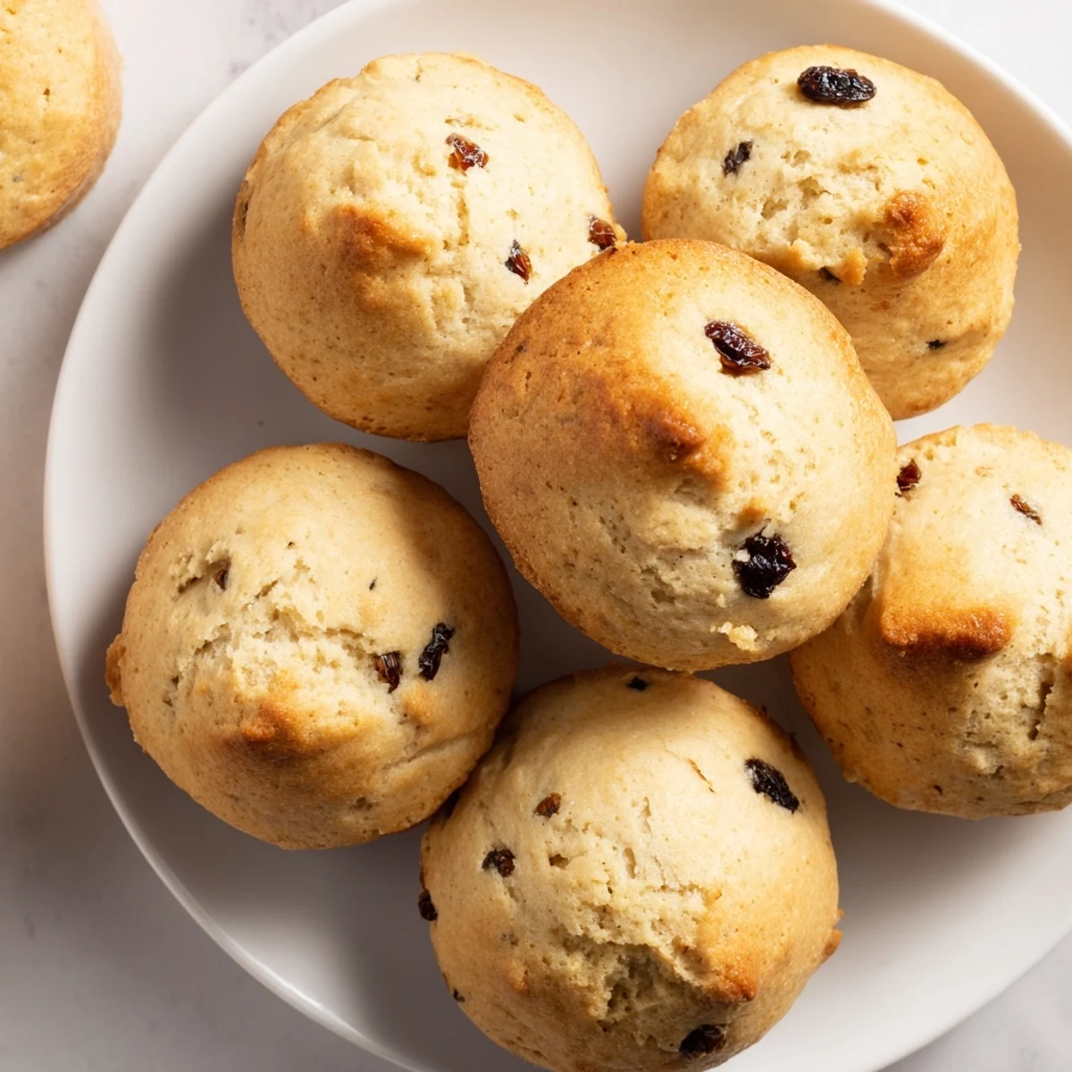 Golden-brown Irish Soda Bread Muffins studded with juicy currants, fresh from the oven.