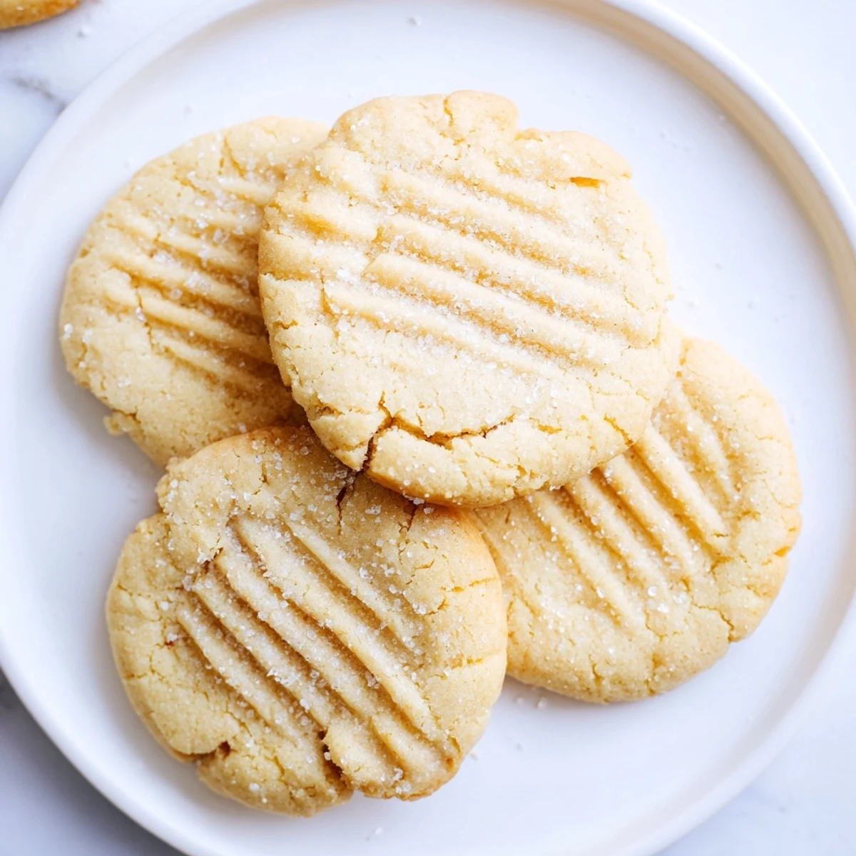 Freshly baked Keto Butter Cookies on a wooden board with a crisscross pattern, lightly golden edges, and a soft texture ready to serve.