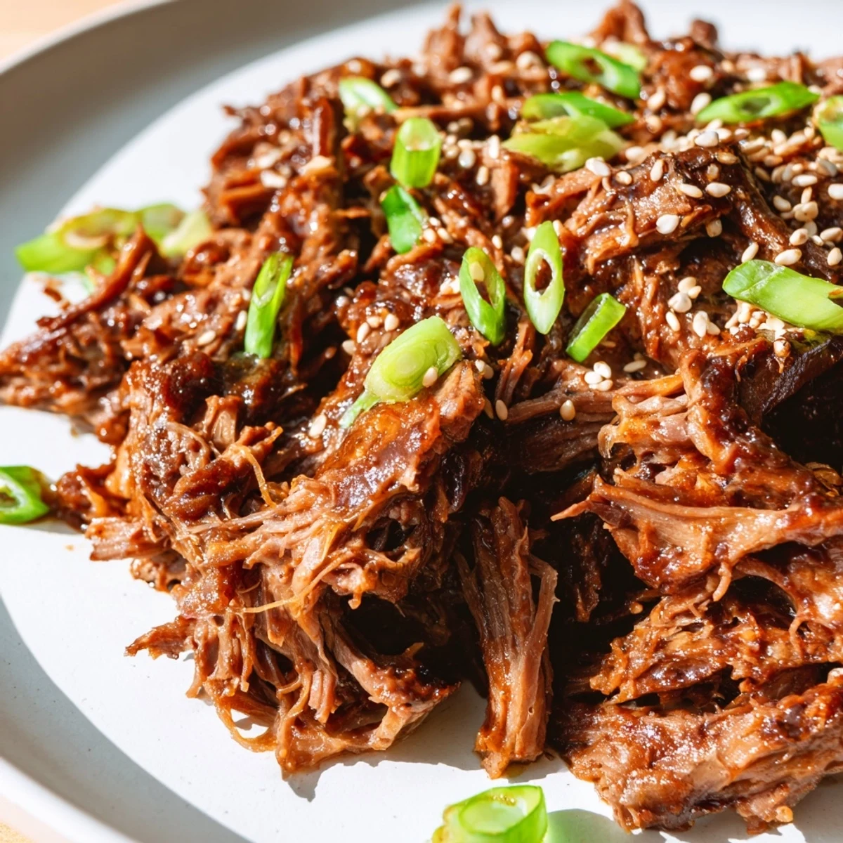 Hearty serving of Crock Pot Korean Beef in a bowl with steamed vegetables and kimchi for a spicy kick.