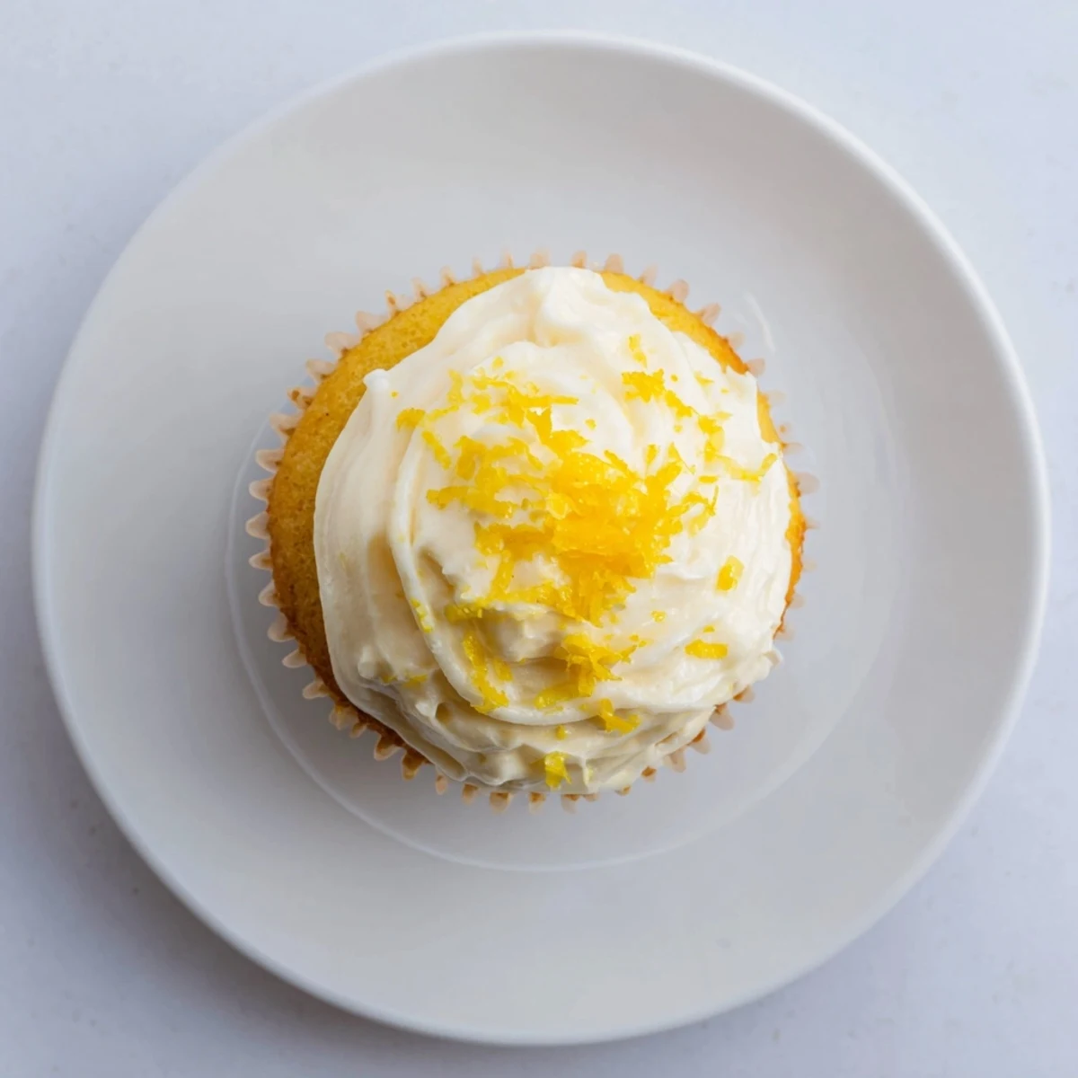 Delicious Limoncello Cupcakes arranged on a spring dessert table, bright citrus glaze glistening under sunlight.