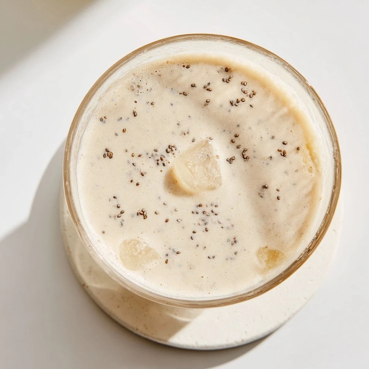 Thick and refreshing Greek yogurt banana smoothie blended with ice and a dusting of cinnamon