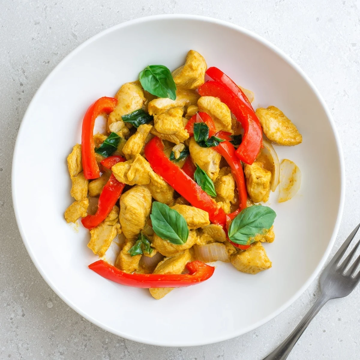 Tender chicken simmered in fragrant coconut curry sauce topped with fresh chopped basil leaves