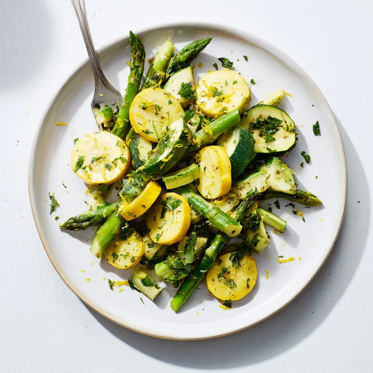Colorful Mediterranean vegetable side dish featuring crisp asparagus zucchini and squash with parsley