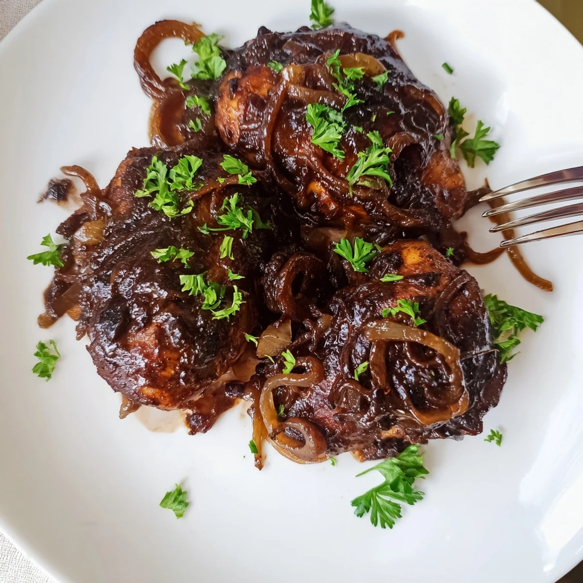 Tender slow cooker balsamic chicken served over fluffy white rice with caramelized onions