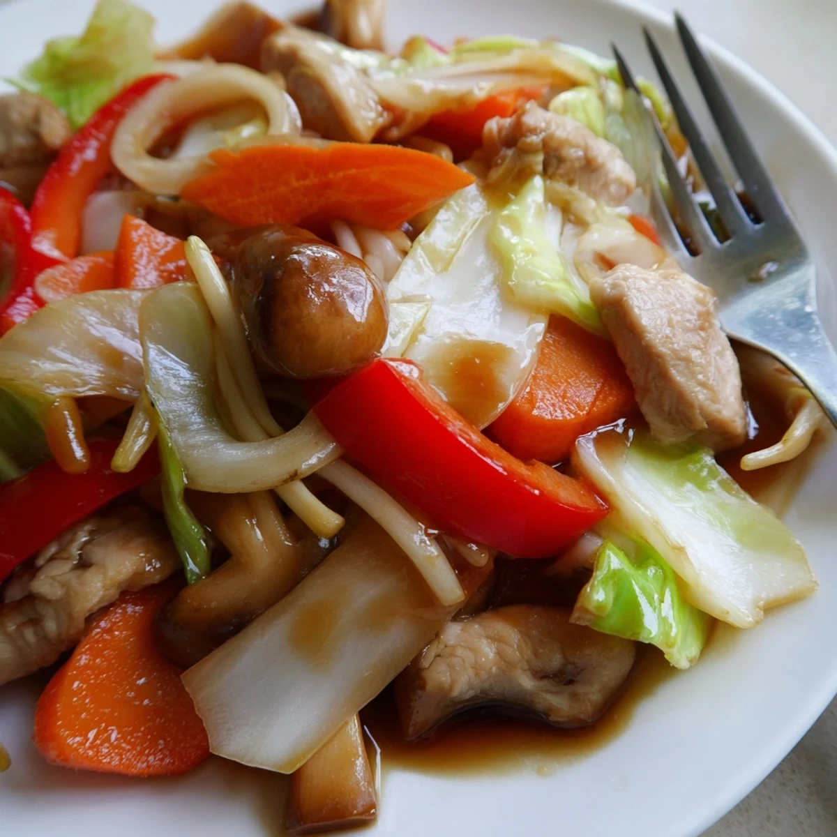 Colorful Chop Suey stir-fry featuring tender chicken and crisp vegetables in glossy brown sauce