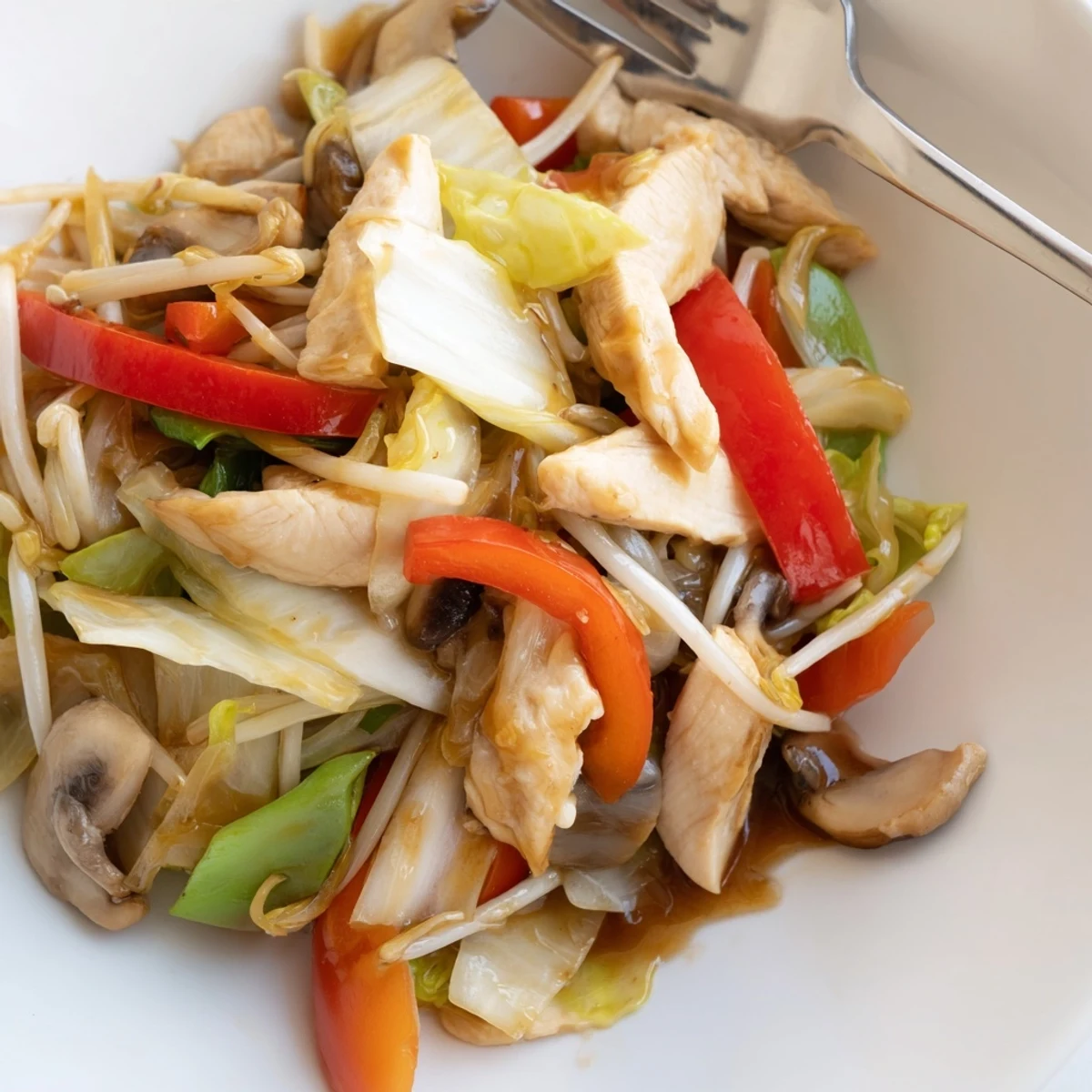 Savory Chinese-American Chop Suey served over steamed rice with crunchy bean sprouts and peppers