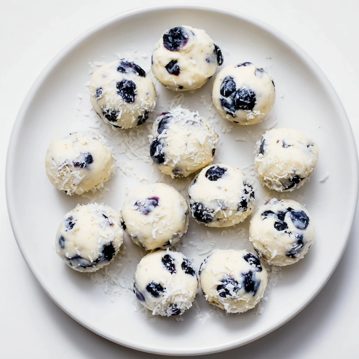Close-up of creamy blueberry cheesecake protein bites with visible blueberry pieces and smooth texture