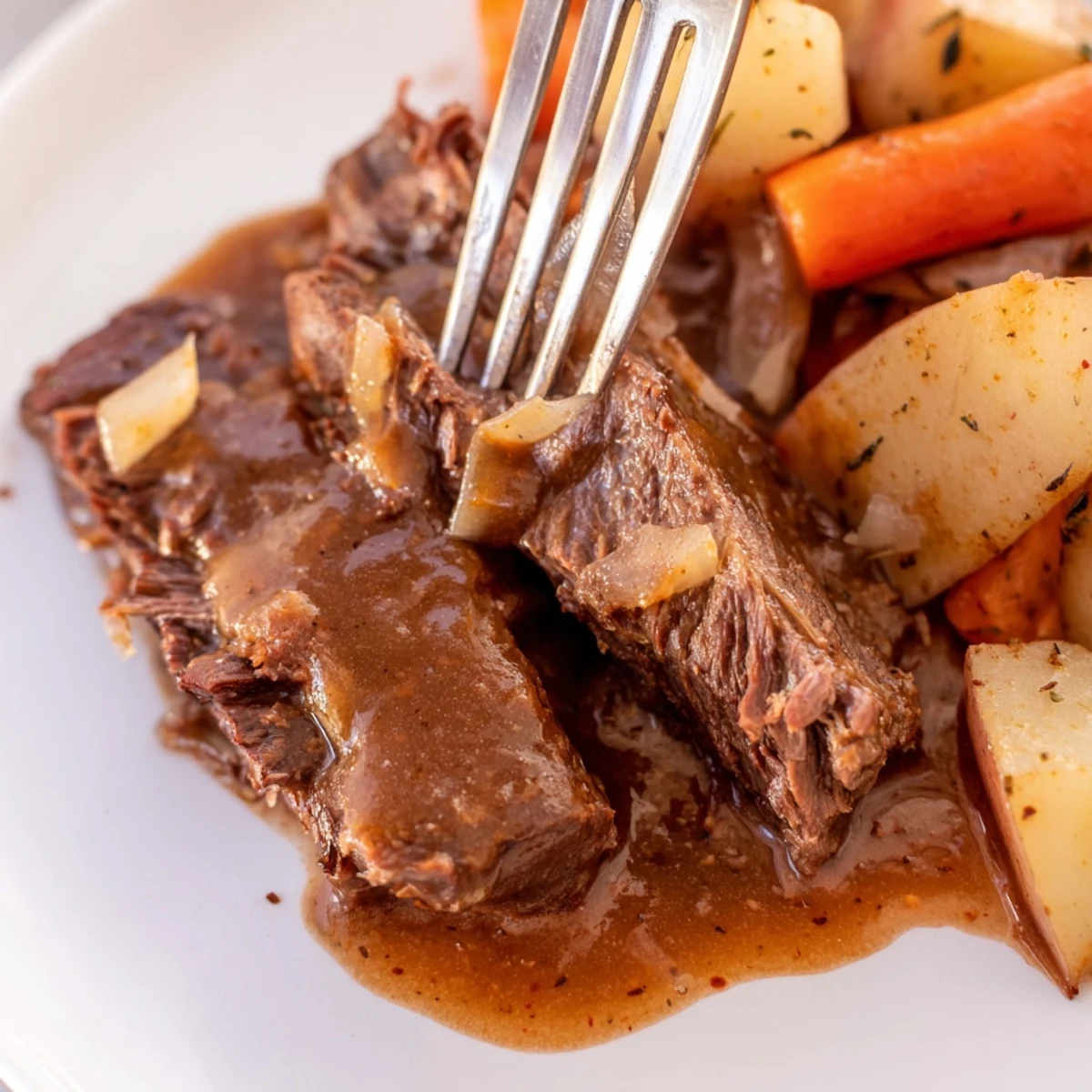 Southern style pot roast plate featuring tender beef with carrots and potatoes in rich brown gravy