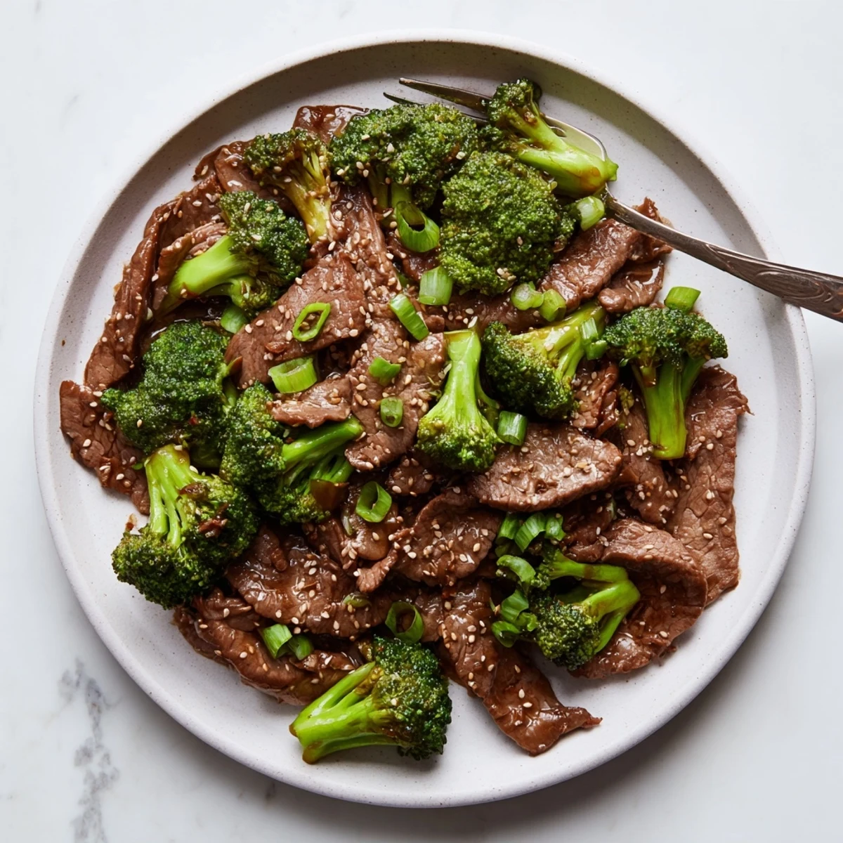 Instant Pot Beef and Broccoli featuring tender beef slices and crisp florets coated in glossy savory sauce
