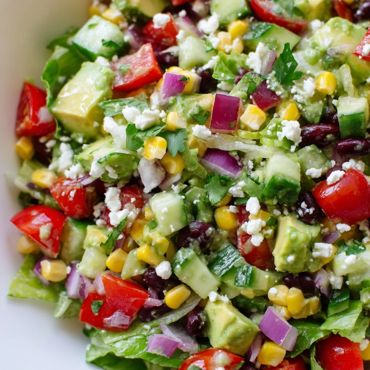 Fresh Mexican chopped salad in a bowl with colorful vegetables and zesty lime dressing