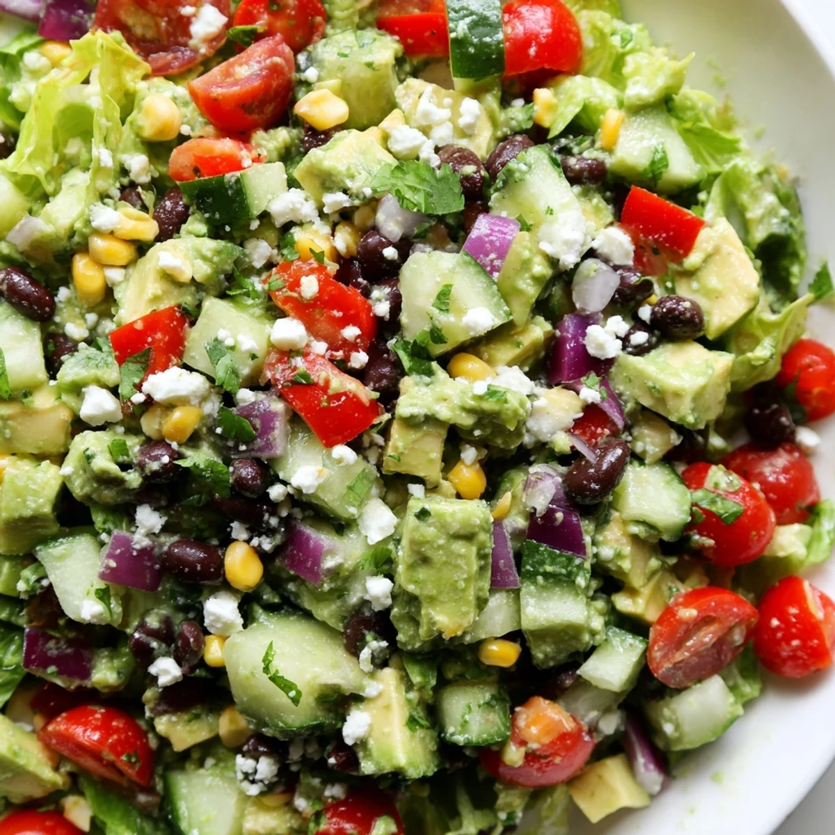 Mexican chopped salad topped with crumbled cotija cheese avocado and crisp vegetables
