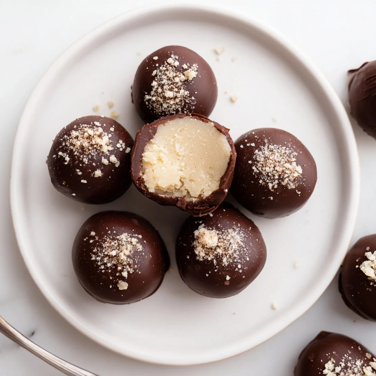 Plated Dark Chocolate Eggnog Truffles dusted with cinnamon, perfect for holiday gifting