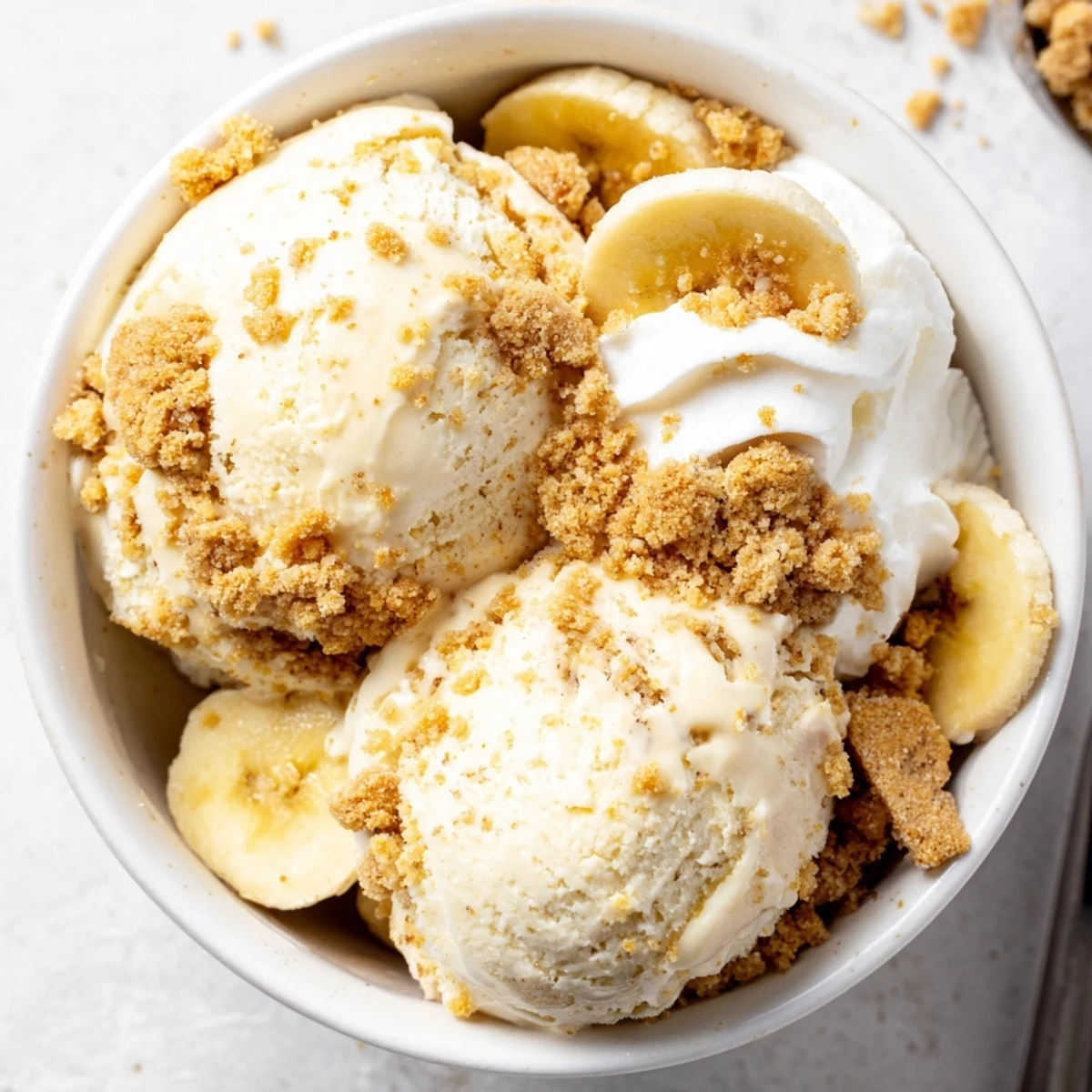 Sweet, silky Ninja Creami Banana Cream Pie Ice Cream garnished with banana slices