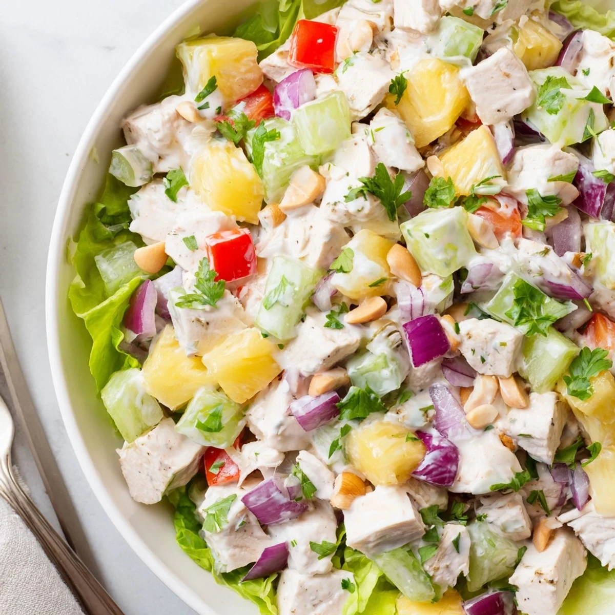 Chilled Hawaiian Chicken Salad Recipe served in halved pineapple for summer gatherings