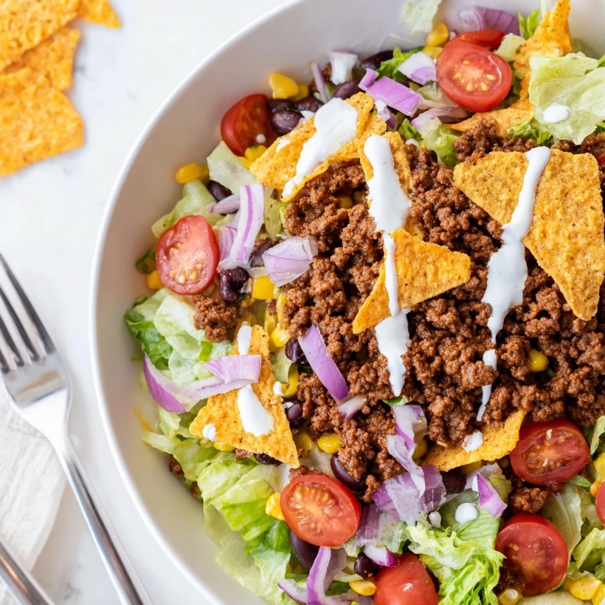 Simple Doritos Taco Salad piled high with crunchy chips and melted cheddar