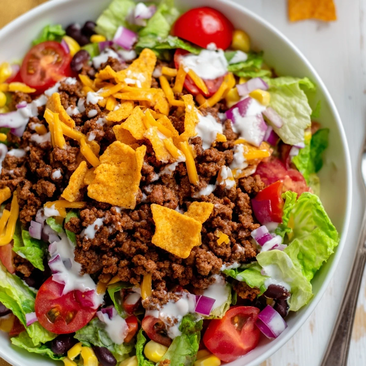 Bowl of Simple Doritos Taco Salad with warm seasoned beef, tangy dressing