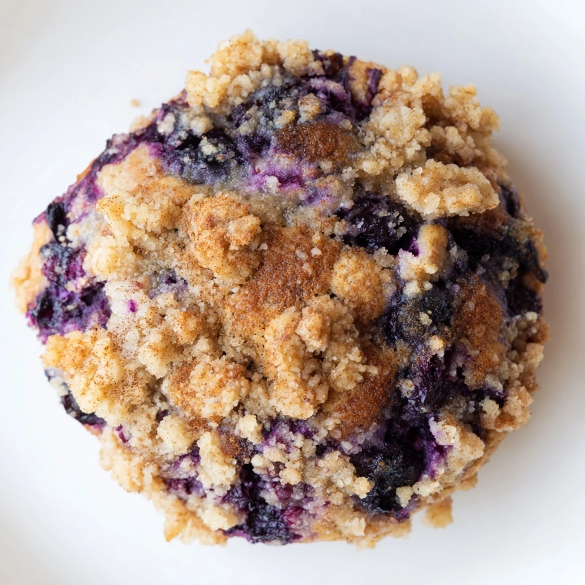 Cake-like blueberry muffin cookies bursting with juicy fruit under sweet brown sugar crumble