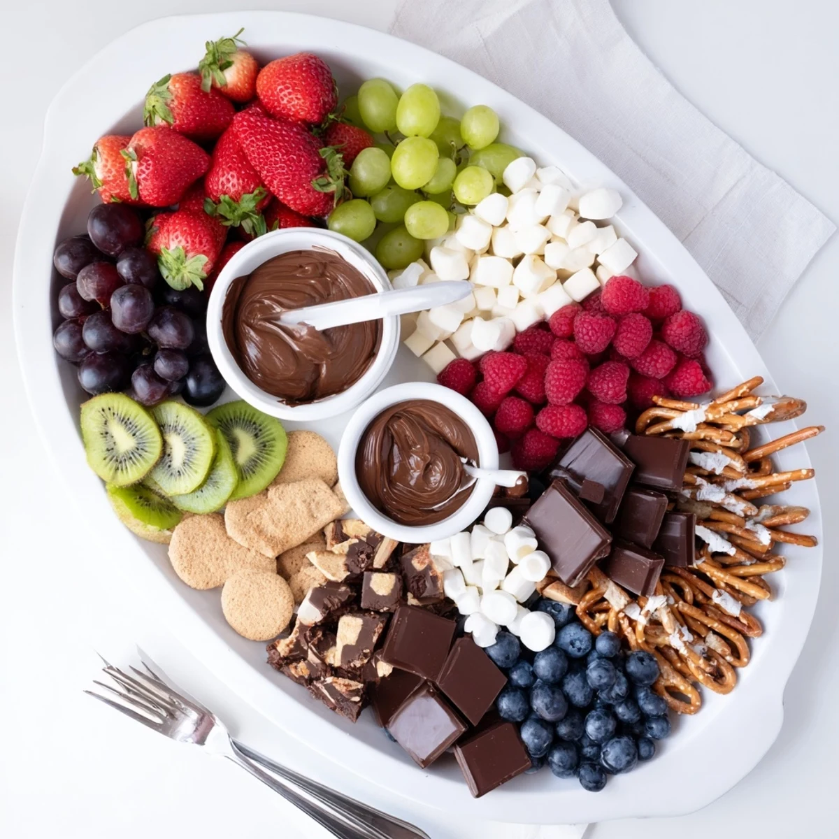 Ready to share Dessert Charcuterie Board with bowls of caramel and marshmallow.
