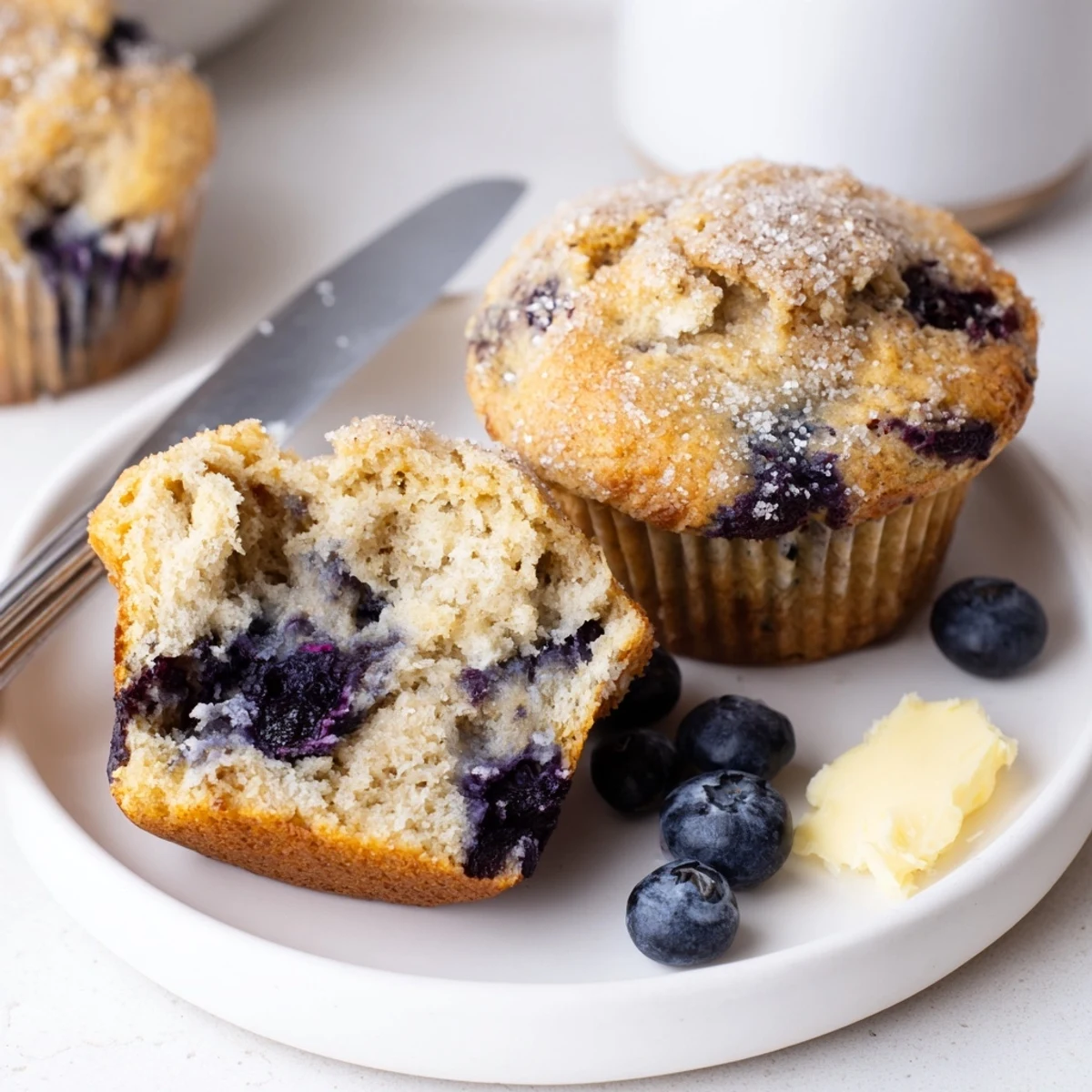 Homestyle Blueberry Banana Muffins studded with blueberries, banana aroma, tender crumb.