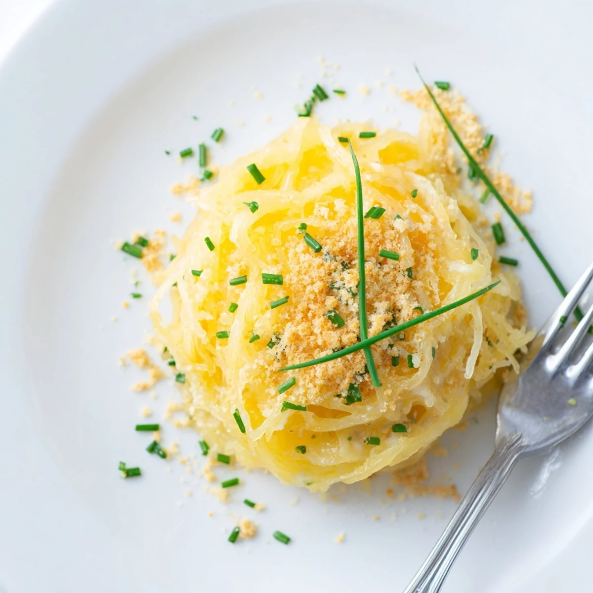 Comforting spaghetti squash mac and cheese casserole bubbling with golden cheesy topping and fresh herbs