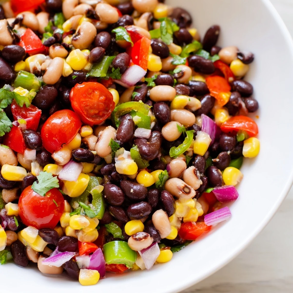 Colorful cowboy caviar recipe bursting with fresh beans, peppers, and zesty lime dressing